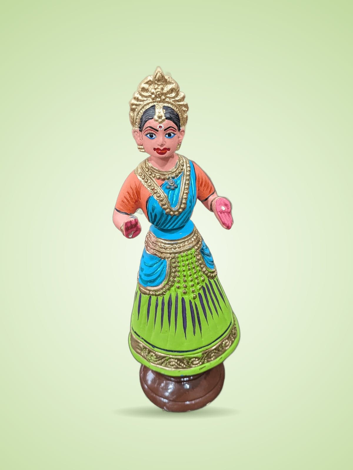 The intricate hand-painted detail of a traditional Kondapalli doll